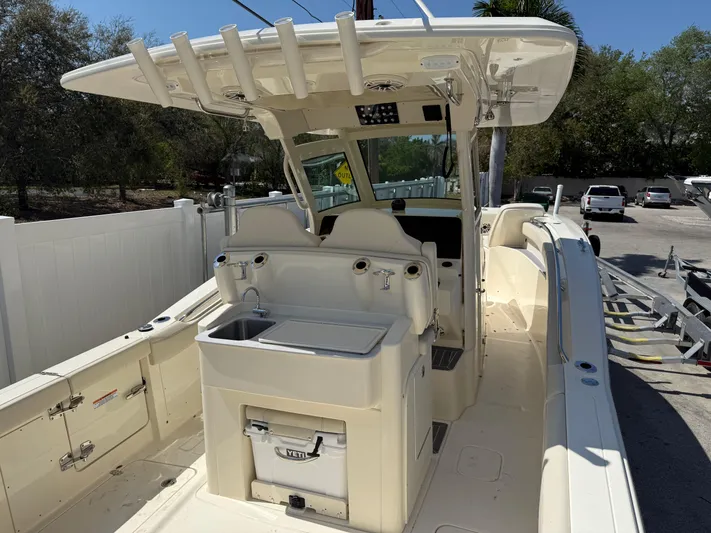  Yacht Photos Pics 2025 Scout 305 LXF boat interior with helm station and seating area.