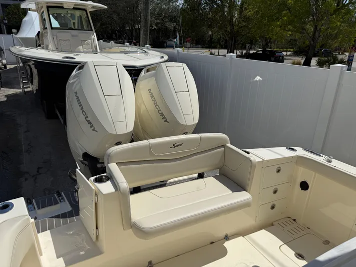  Yacht Photos Pics 2025 Scout 305 LXF boat with dual Mercury engines, featuring a spacious seating area.