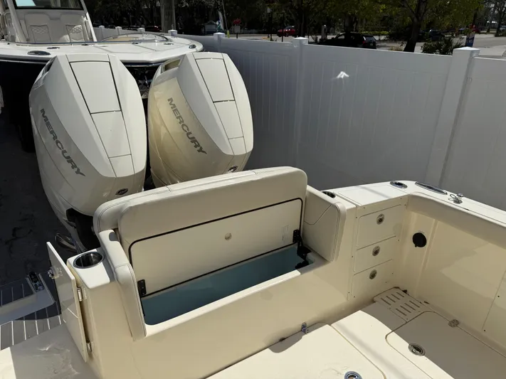  Yacht Photos Pics 2025 Scout 305 LXF boat with dual Mercury engines, featuring spacious seating and storage.
