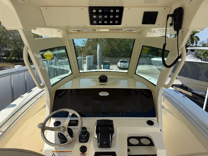  Yacht Photos Pics Helm of 2025 Scout 305 LXF boat with modern controls and steering wheel.