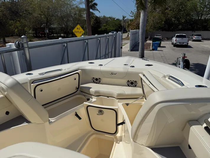  Yacht Photos Pics 2025 Scout 305 LXF boat interior with open storage compartments and seating.