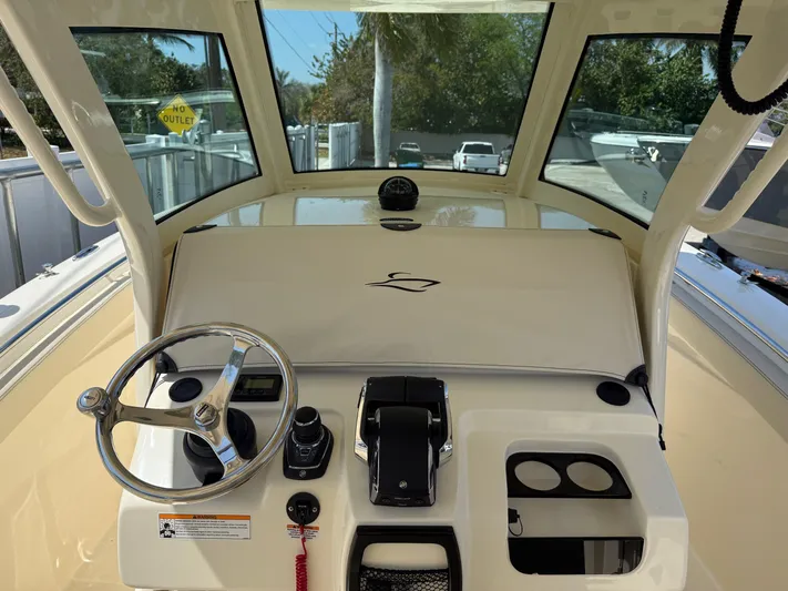  Yacht Photos Pics 2025 Scout 305 LXF boat dashboard with steering wheel and controls.