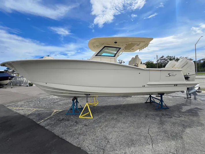  Yacht Photos Pics 2025 Scout 305 LXF boat on stands under a clear blue sky.