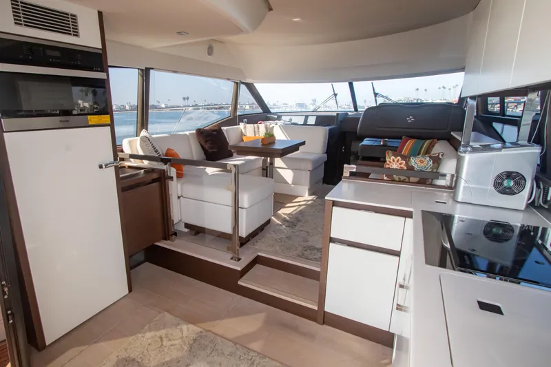 Fantasea Yacht Photos Pics Interior of 2020 Prestige 460 Fly yacht with modern kitchen and seating area.