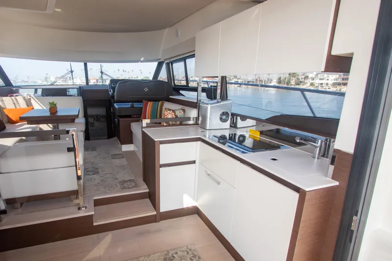 Fantasea Yacht Photos Pics Interior of 2020 Prestige 460 Fly yacht with modern kitchen and seating area.