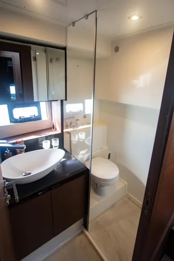Fantasea Yacht Photos Pics Modern bathroom in 2020 Prestige 460 Fly yacht with sink, toilet, and mirror.