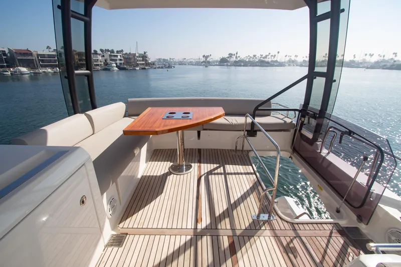 Fantasea Yacht Photos Pics Prestige 460 Fly 2020 yacht flybridge with seating and table, overlooking marina.