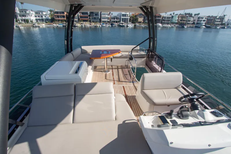 Fantasea Yacht Photos Pics Prestige 460 Fly 2020 yacht flybridge with seating, table, and waterfront view.