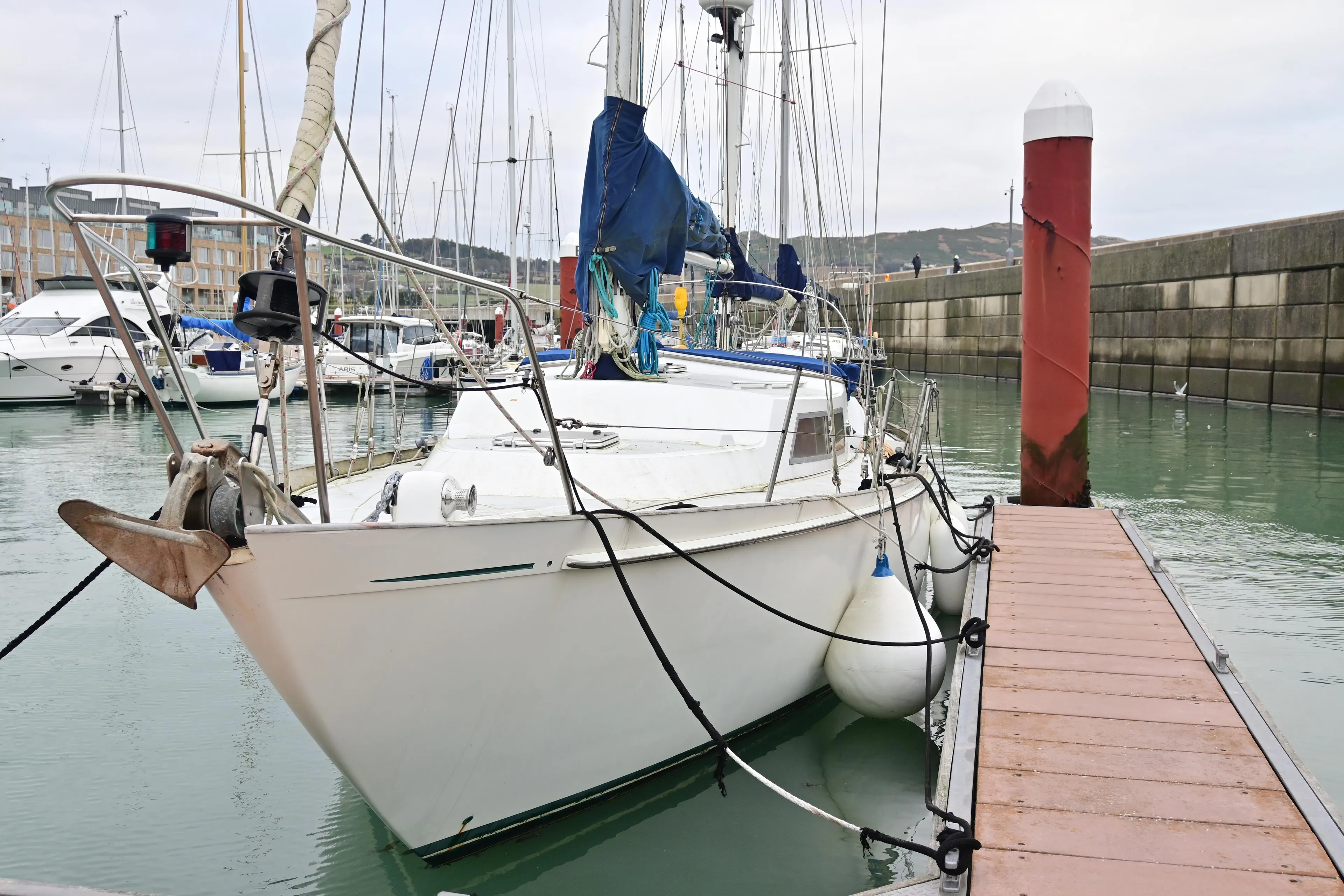 1978 Nicholson 48 Ketch moored at a marina dock.