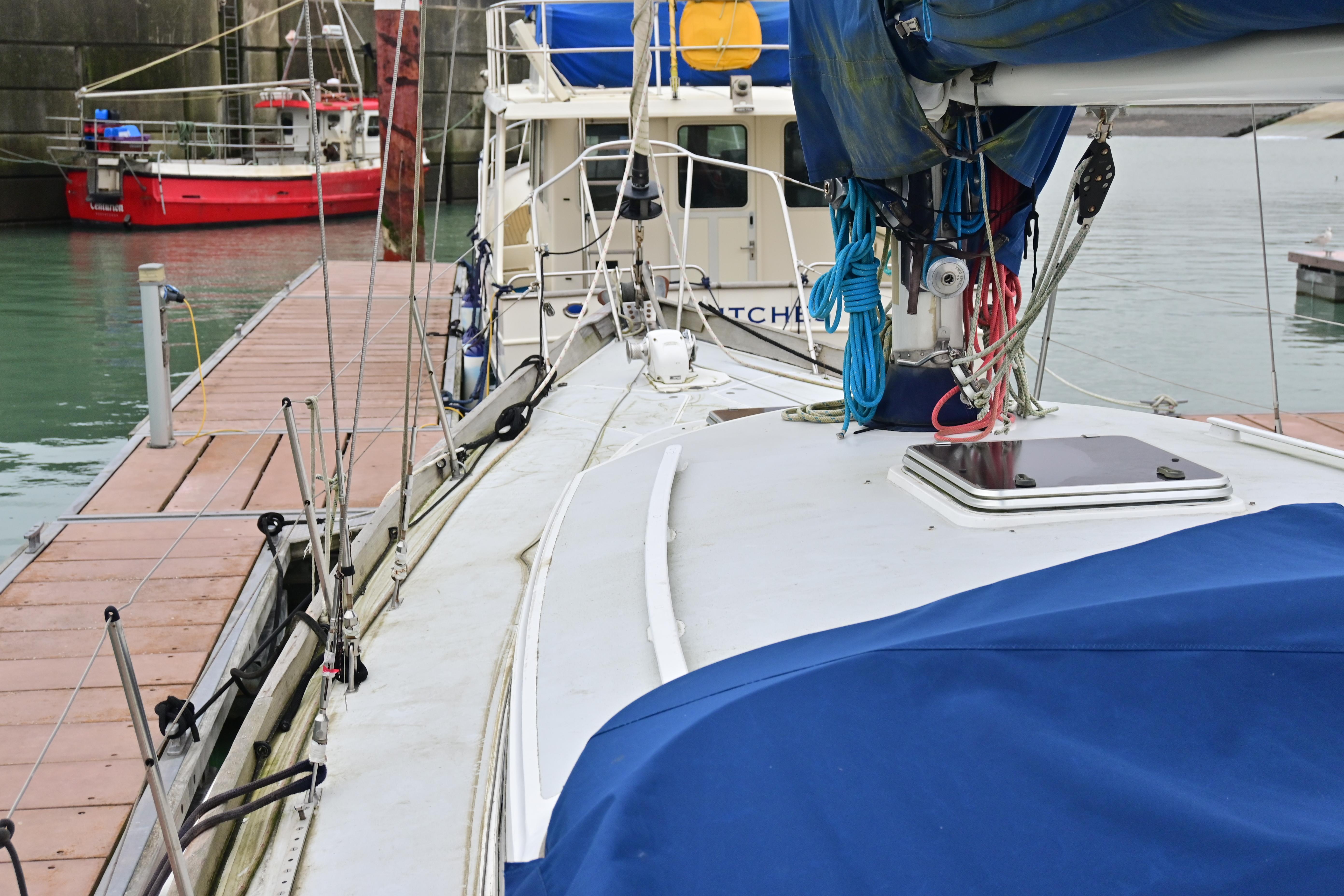 1978 Nicholson 48 Ketch docked at marina with blue sail cover.