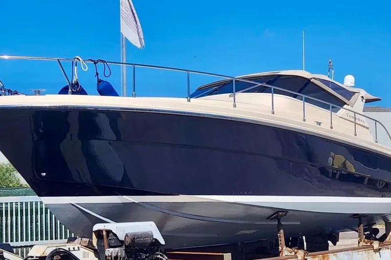  Yacht Photos Pics 1998 Cayman Yachts 40 W.A. boat on display under clear blue sky.