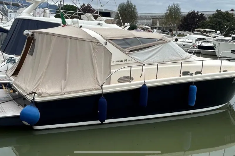  Yacht Photos Pics 1998 Cayman Yachts 40 W.A. docked, featuring blue fenders and beige canopy.