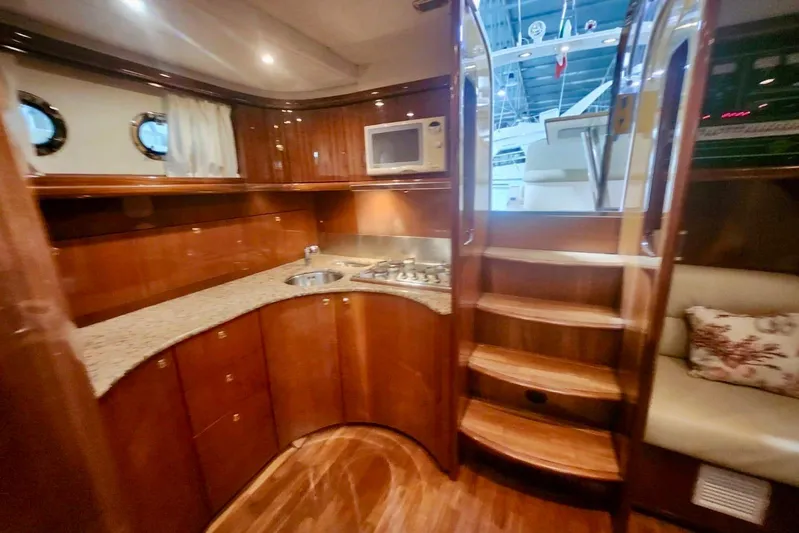  Yacht Photos Pics Luxurious 1998 Cayman Yachts 40 W.A. interior with wooden cabinetry and modern kitchen amenities.