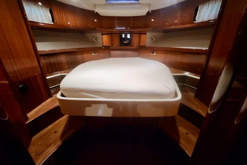  Yacht Photos Pics Luxurious cabin interior of 1998 Cayman Yachts 40 W.A. with wooden finishes and cozy bed.