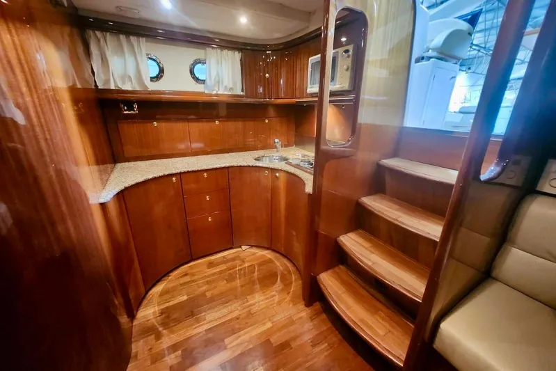  Yacht Photos Pics Luxurious wooden interior of 1998 Cayman Yachts 40 W.A. with kitchenette and stairs.