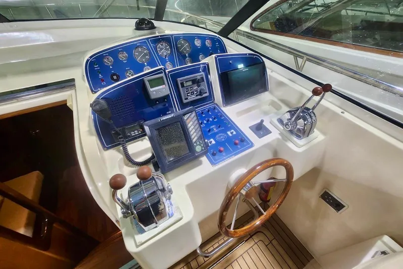  Yacht Photos Pics Cockpit of 1998 Cayman Yachts 40 W.A. with navigation instruments and wooden steering wheel.