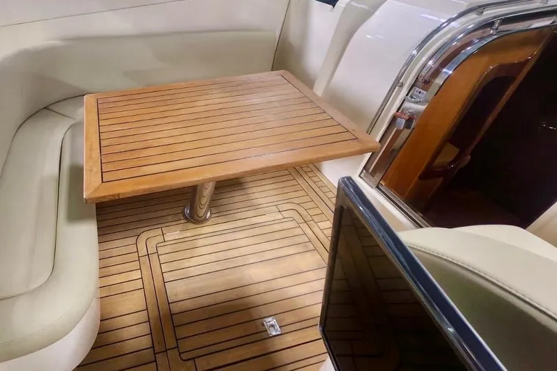  Yacht Photos Pics Luxurious interior of 1998 Cayman Yachts 40 W.A. with wooden table and seating.