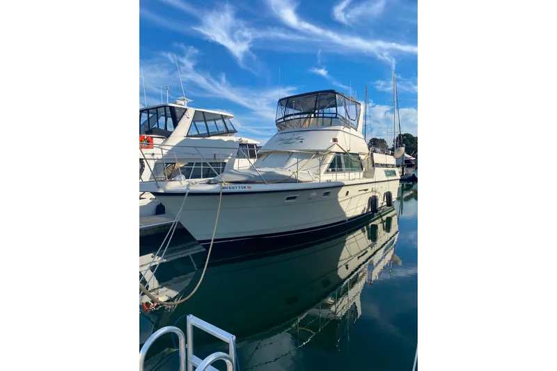  Yacht Photos Pics 1988 Hatteras 40 Double Cabin yacht docked in a marina under a clear blue sky.