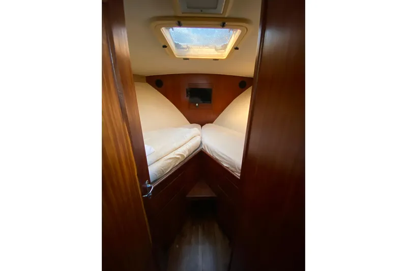  Yacht Photos Pics 1988 Hatteras 40 Double Cabin interior with twin beds and wooden finish.