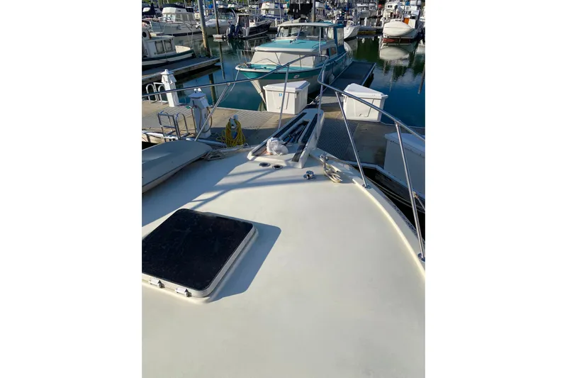  Yacht Photos Pics 1988 Hatteras 40 Double Cabin yacht docked at marina, showing deck and surrounding boats.