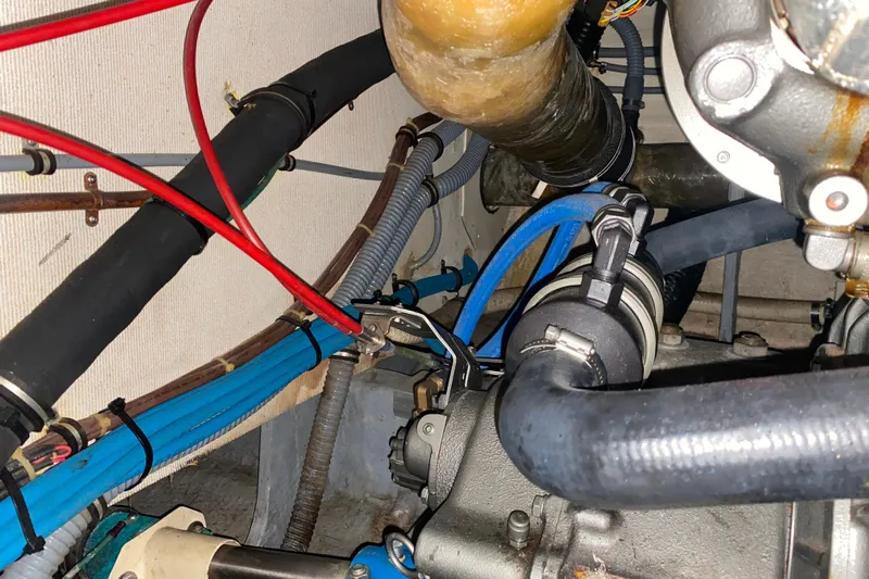  Yacht Photos Pics Engine room of 1988 Hatteras 40 Double Cabin with visible hoses and wiring.