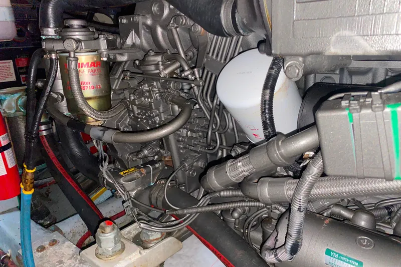  Yacht Photos Pics Engine compartment of a 1988 Hatteras 40 Double Cabin boat, showcasing detailed machinery.