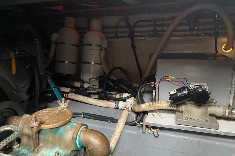  Yacht Photos Pics Engine room of 1988 Hatteras 40 Double Cabin with visible pipes and machinery.