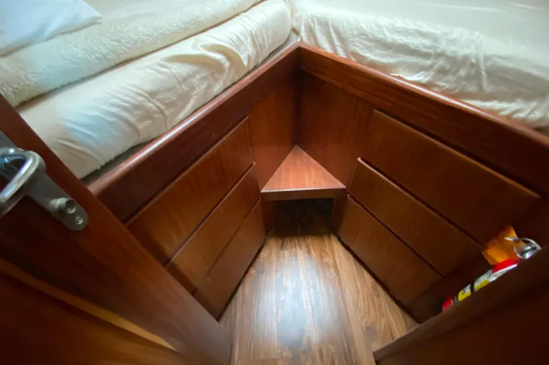  Yacht Photos Pics Cozy cabin interior of 1988 Hatteras 40 Double Cabin with wooden drawers and bed.