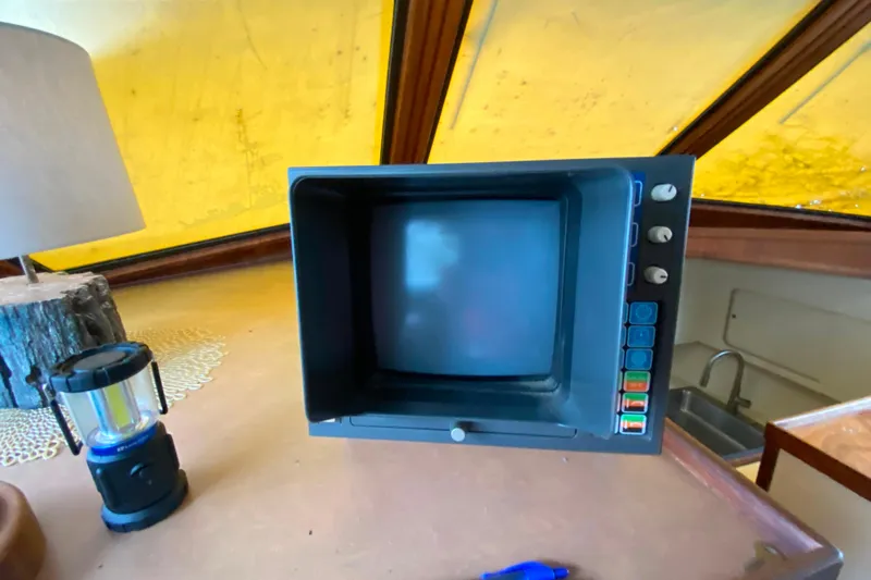  Yacht Photos Pics Vintage monitor inside 1988 Hatteras 40 Double Cabin yacht, with lamp and lantern nearby.
