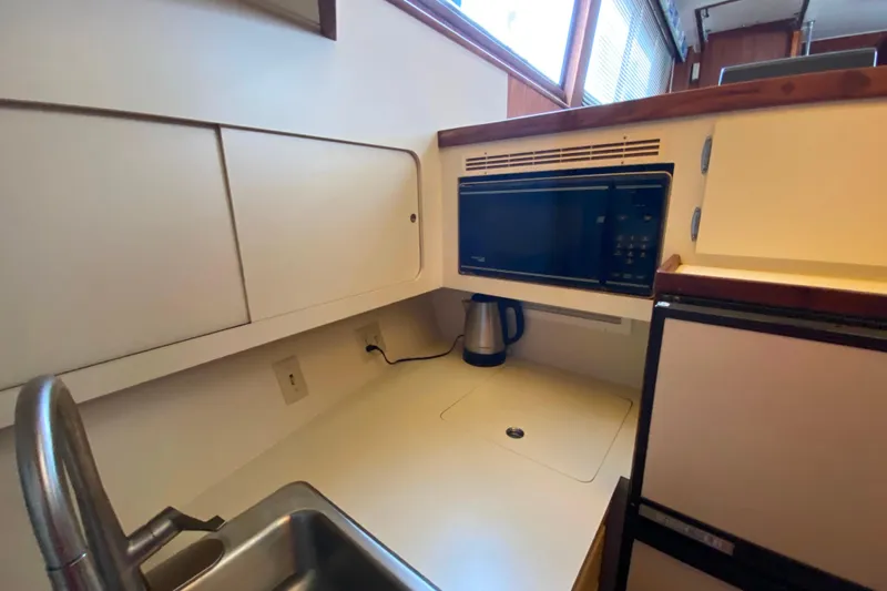 Yacht Photos Pics 1988 Hatteras 40 Double Cabin kitchen with microwave, sink, and kettle.