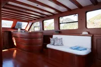 Luxurious 2020 custom schooner interior with wooden finish and scenic window views.