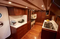 Luxurious 2020 custom schooner kitchen with wooden cabinetry and modern appliances.