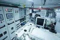 Engine room of a 2020 Custom Schooner, featuring control panels and machinery.