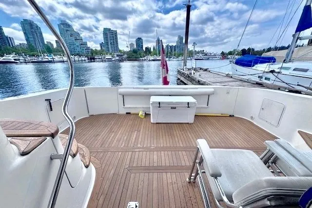 Hustler I Yacht Photos Pics 2000 Sea Ray 560 Sedan Bridge yacht deck with city skyline and marina view.