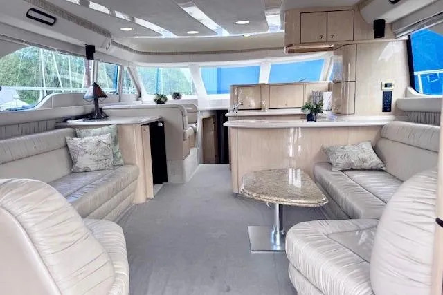 Hustler I Yacht Photos Pics Luxurious interior of a 2000 Sea Ray 560 Sedan Bridge yacht with elegant seating and decor.