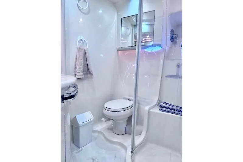 Hustler I Yacht Photos Pics Luxurious bathroom in 2000 Sea Ray 560 Sedan Bridge yacht, featuring modern fixtures and elegant design.