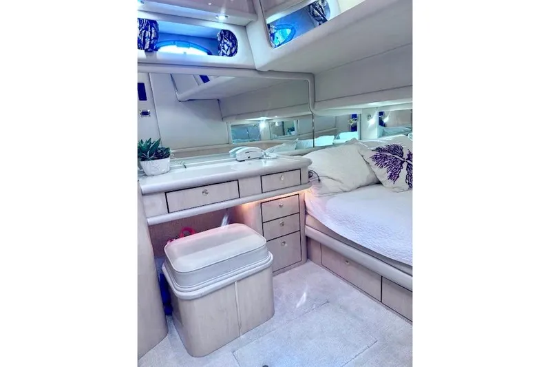 Hustler I Yacht Photos Pics Luxurious interior of 2000 Sea Ray 560 Sedan Bridge yacht bedroom with elegant furnishings.