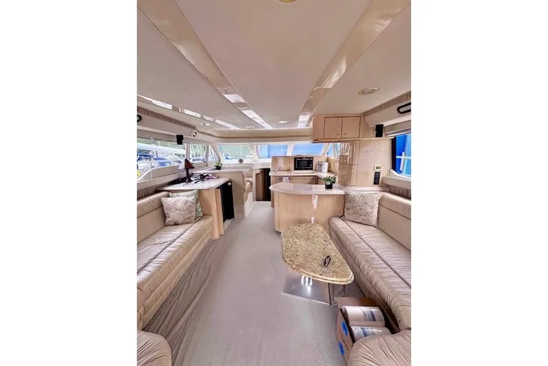 Hustler I Yacht Photos Pics Luxurious interior of a 2000 Sea Ray 560 Sedan Bridge yacht with elegant seating and kitchen.