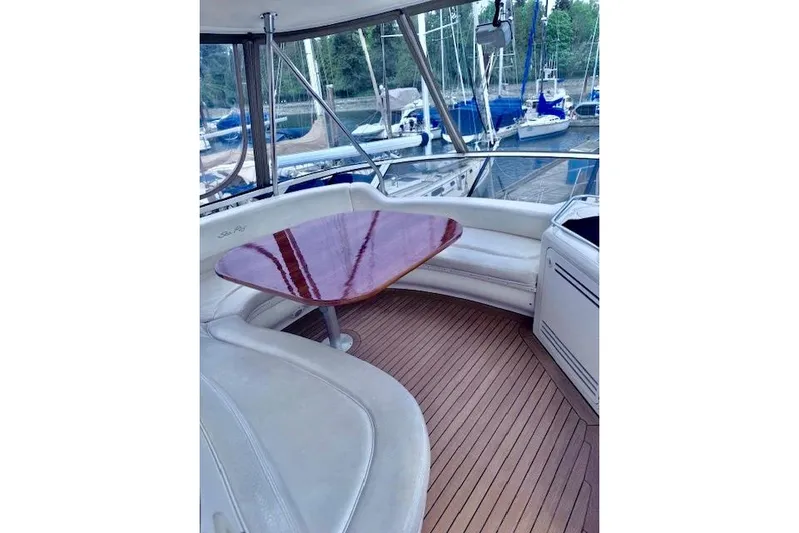 Hustler I Yacht Photos Pics Luxurious 2000 Sea Ray 560 Sedan Bridge yacht interior with elegant seating and polished wood table.