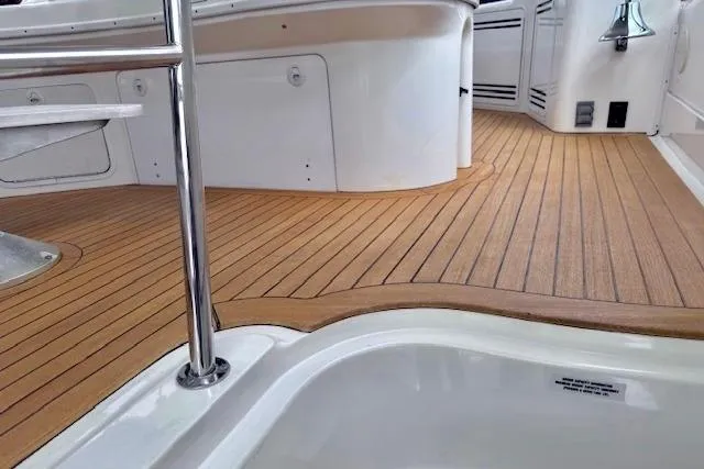 Hustler I Yacht Photos Pics 2000 Sea Ray 560 Sedan Bridge yacht with teak deck and stainless steel railing.