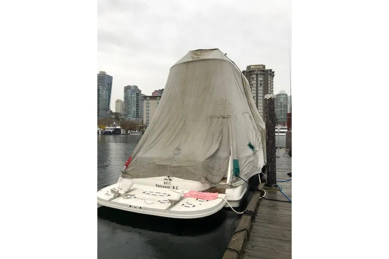 Hustler I Yacht Photos Pics Covered 2000 Sea Ray 560 Sedan Bridge docked in urban marina setting.