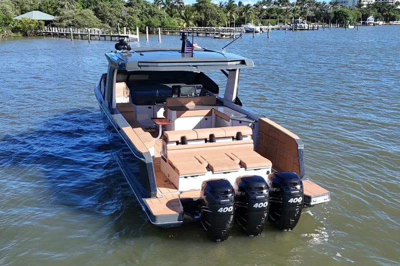  Yacht Photos Pics 2022 Aviara AV40 OB boat with triple Mercury 400 engines on a calm waterway.
