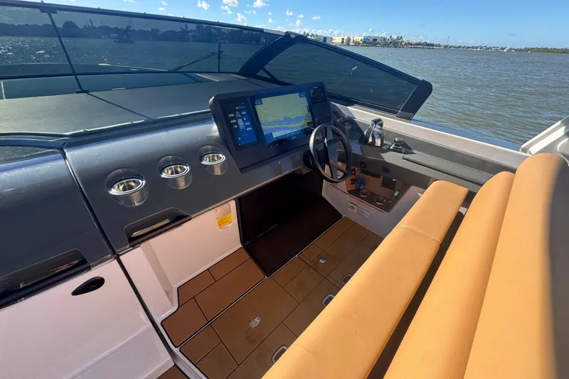  Yacht Photos Pics 2022 Aviara AV40 OB boat cockpit with modern navigation system and tan seating.