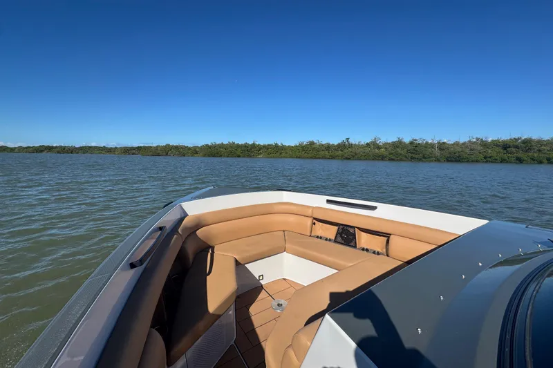  Yacht Photos Pics 2022 Aviara AV40 OB boat with tan seating on a calm lake under clear blue skies.