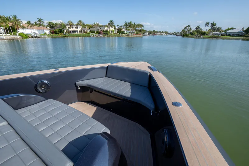  Yacht Photos Pics 2025 Pardo Yachts 50, luxury seating area on calm water, surrounded by palm trees.