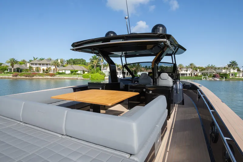  Yacht Photos Pics Luxurious 2025 Pardo Yachts 50 with elegant seating and table, docked by waterfront homes.