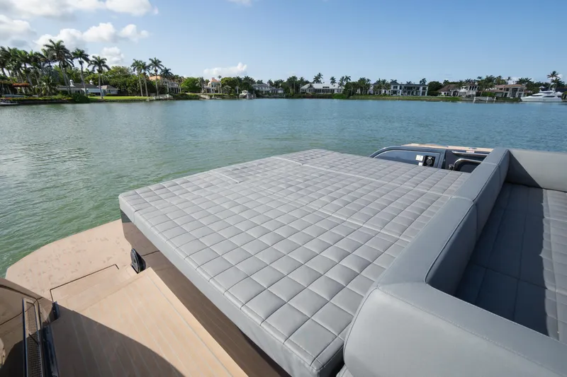  Yacht Photos Pics Luxurious 2025 Pardo Yachts 50 with spacious sunbed, overlooking serene waterfront and palm trees.