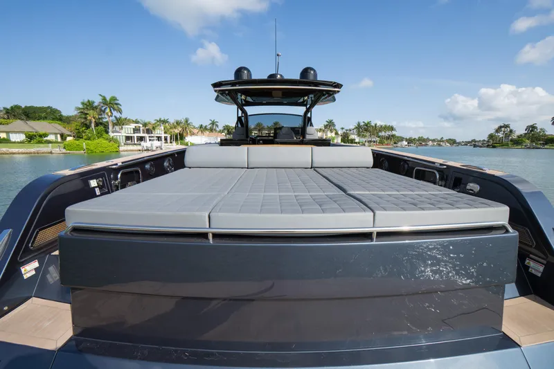  Yacht Photos Pics 2025 Pardo Yachts 50 luxury yacht with spacious sunbathing area, docked by waterfront homes.