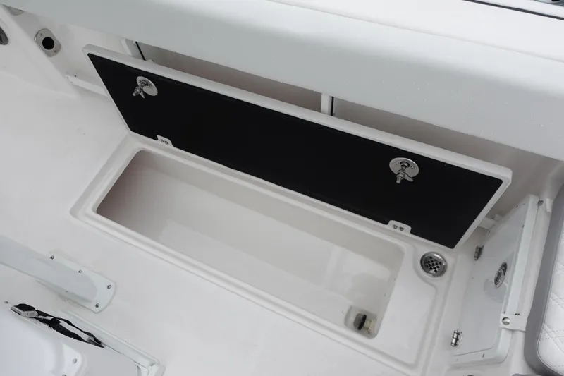  Yacht Photos Pics 2025 Sea Fox 268 Commander boat storage compartment, open with black lid and white interior.