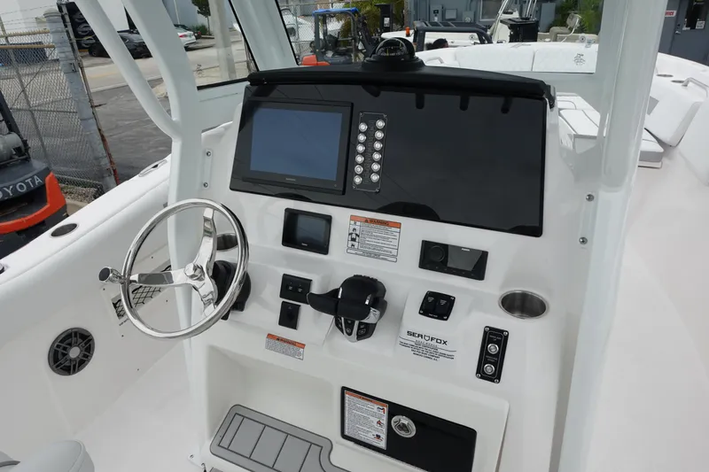  Yacht Photos Pics 2025 Sea Fox 268 Commander boat dashboard with steering wheel and navigation controls.